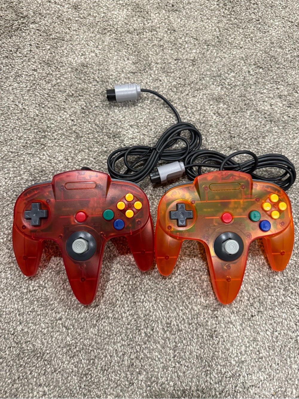 Pair of aftermarket Nintendo N64 Transparent Red/Orange Controllers